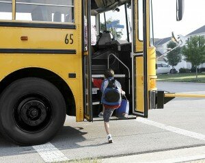 kids getting on a school bus